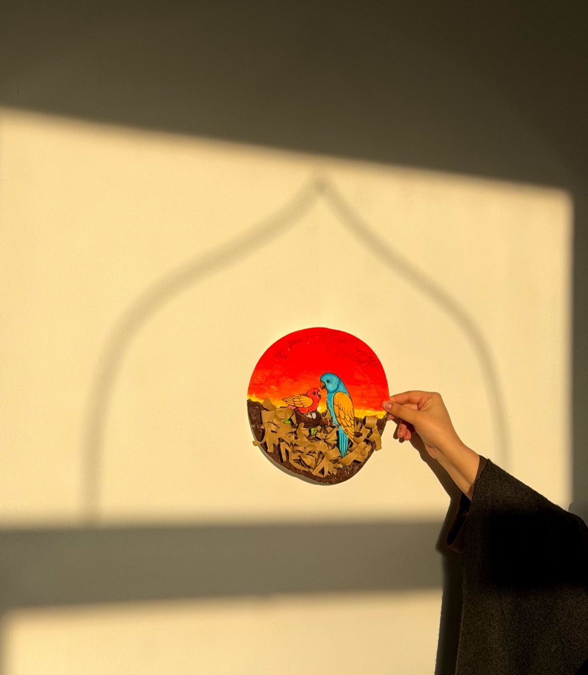 Painted plate held up against a wall